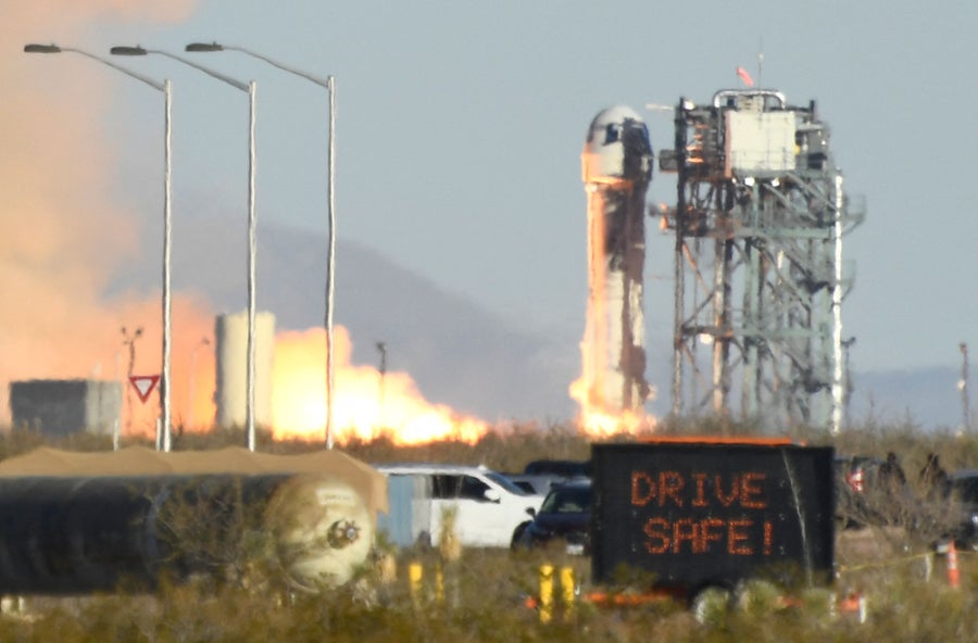 Virgin Galactic SpaceShipTwo takes off in the Mojave Desert, California, seen behind barbed wire fencing